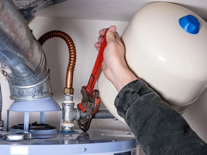Technician repairing a residential water heater